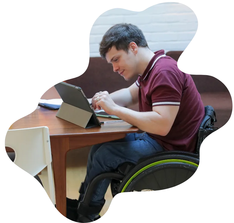 Disabled man in wheelchair using iPad