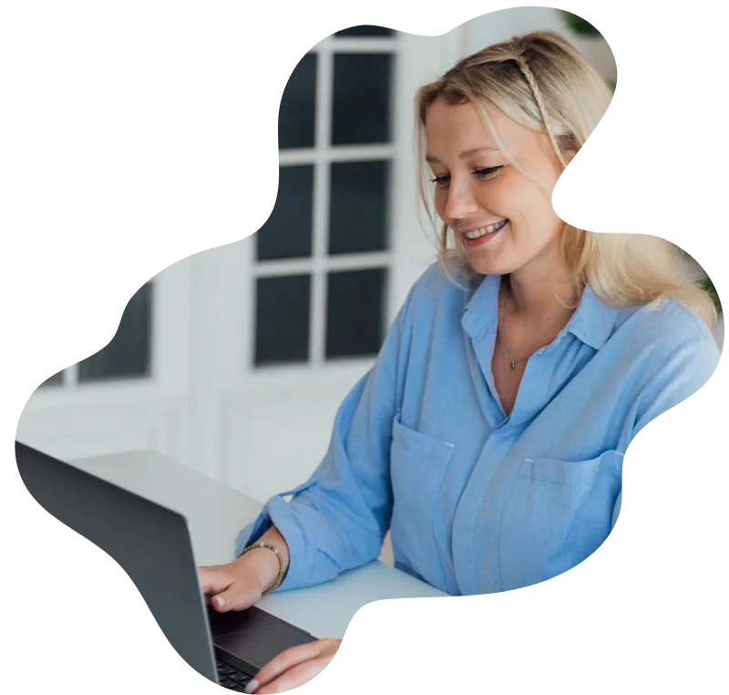 Happy woman making an NDIS referral on her laptop