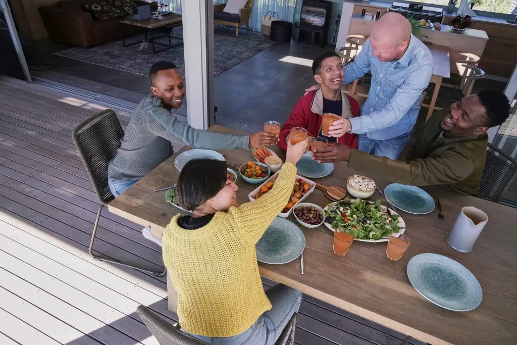 Group of diverse friends making a toast over dinner