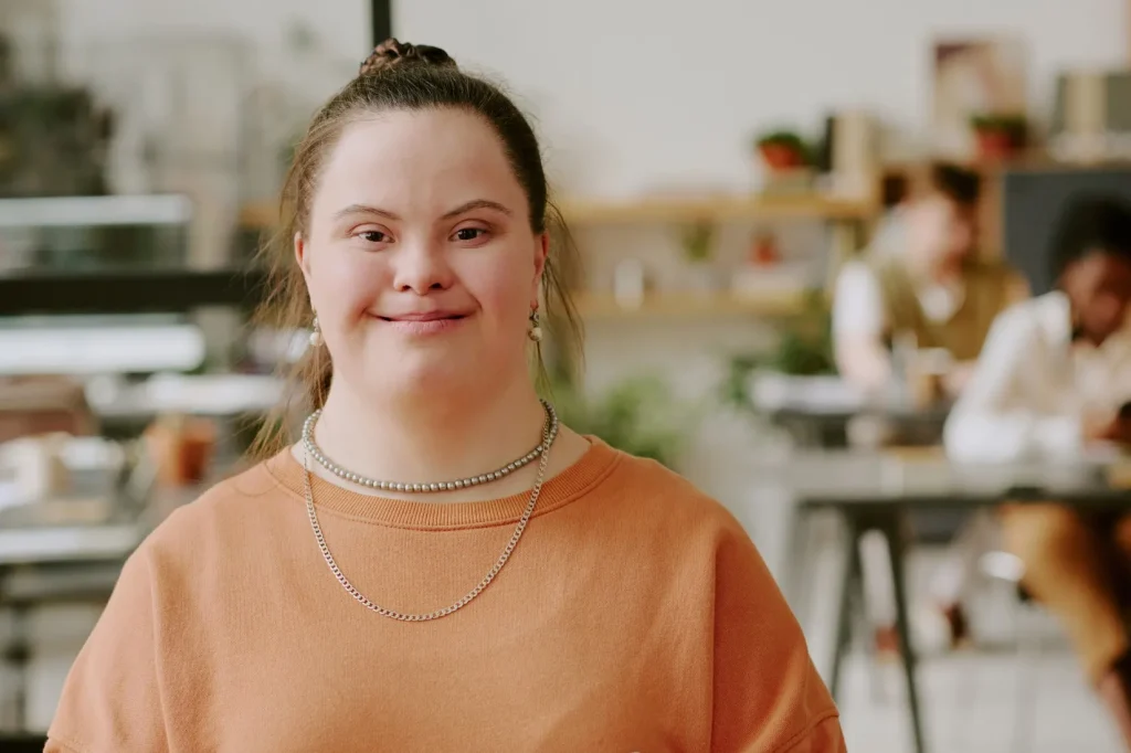 Disabled woman with down syndrome smiling at camera