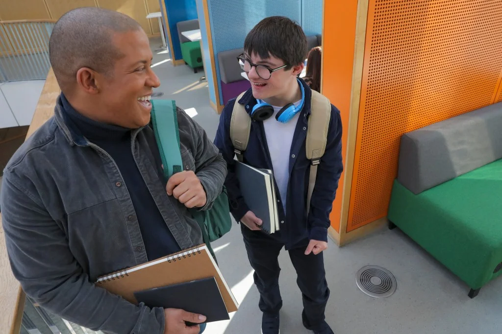 Support worker laughing with disabled man