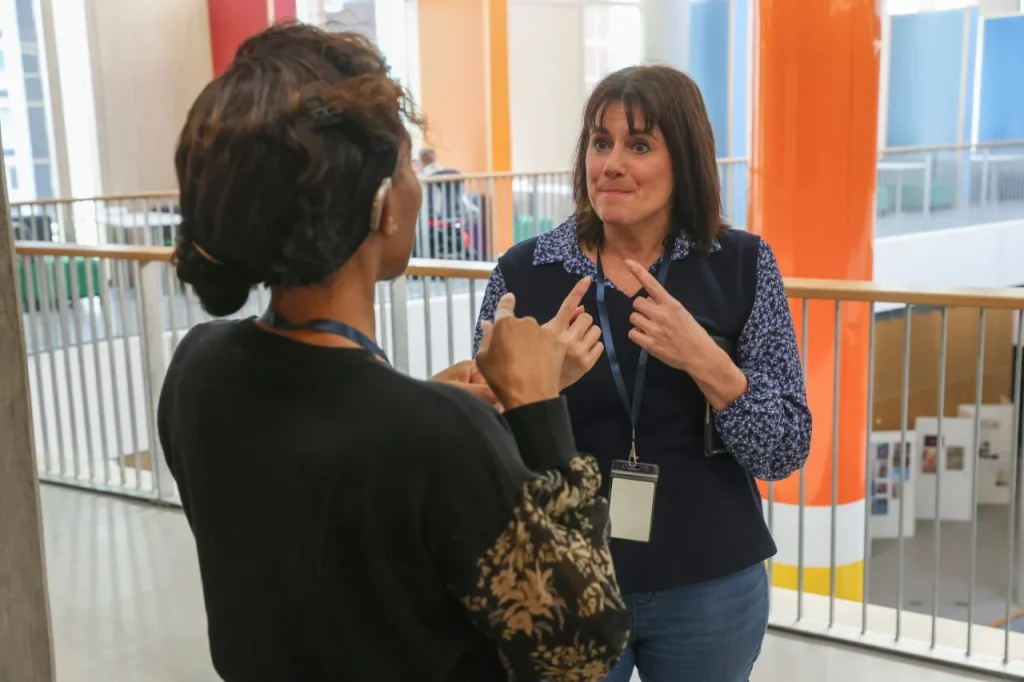 Support worker talking with deaf woman